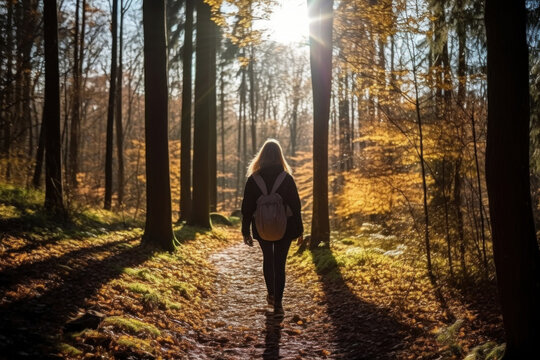 A woman hiking in the forest, finding joy in nature's embrace