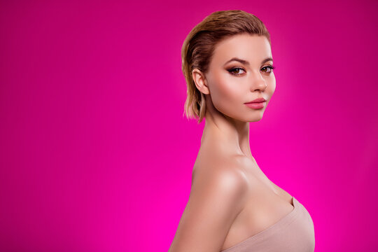 Photo of classy girl stand profile side look mirror after breast enlargement isolated on vivid pink background