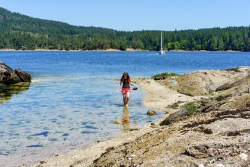 Girl exploring Russell Island, Gulf Islands National Park, British Columbia, Canada 