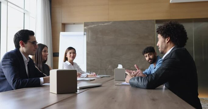 Professional business team lead formal conversation gather together in conference room take part in negotiations, briefing event of staff members, share opinion, ideas, strategy, engaged in teamwork