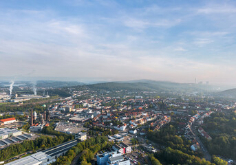 Fototapeta na wymiar Autumn cityscape of Neunkirchen, Saarland, Germany. Wide aerial landscape panorama at sunrise.