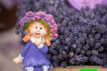 Fototapeta premium A ceramic doll on a lavender background