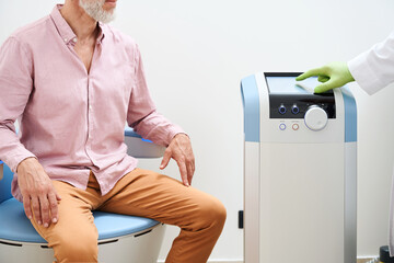 Specialist performs effective procedure for pelvic floor stimulation on patient