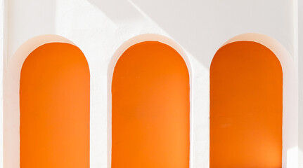 Three white and orange arches, architectural detail in Marbella city, Spain.