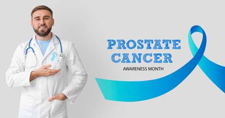 Doctor with light blue ribbon on grey background. November is a Prostate Cancer Awareness Month