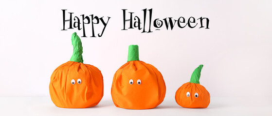 Halloween banner with paper pumpkins on light background