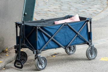 Portable utilitarian folding cart, crib on wheels, travel sleeper. 