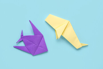 Origami fish and whale on blue background