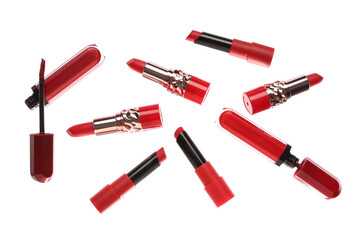 Different modern red lipsticks on white background