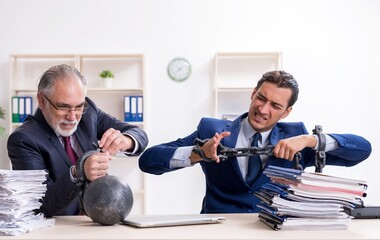 Two male employees unhappy with excessive work