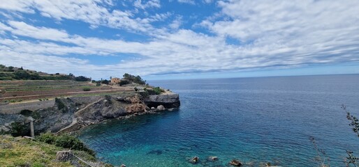 "Banyalbufar," which is a picturesque village located on the western coast of the Spanish island of Mallorca. It's known for its stunning seaside views, terraced vineyards, and charming streets.