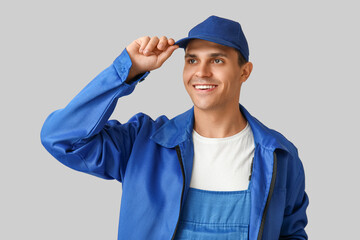 Male car mechanic on grey background