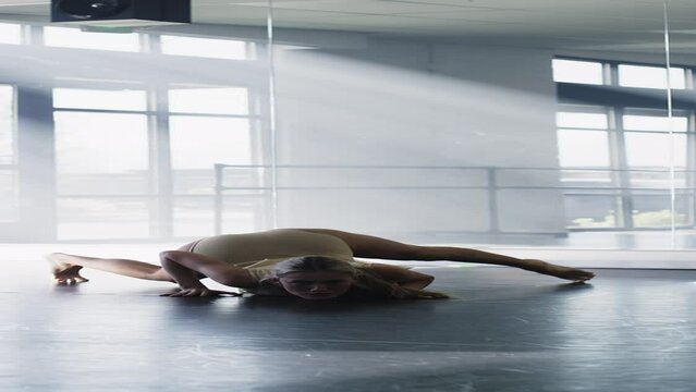 Distant woman practicing contemporary dancing in dance studio - vertical / Lehi, Utah, United States