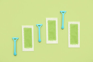 Safety razors with wax strips on green background
