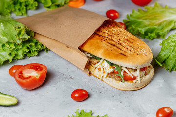 panini sandwich with crispy chicken and rucola salad