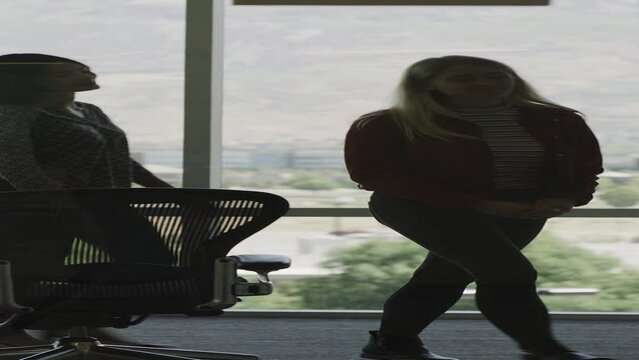Businesswomen shaking hands at meeting then leaving conference room - vertical / Pleasant Grove, Utah, United States