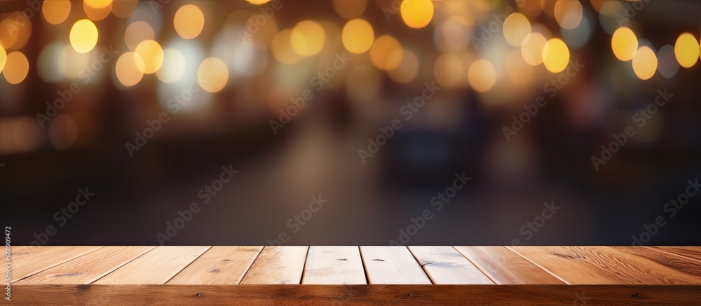 Poster wooden table in front of blurred bokeh background of cafe and restaurant for product display or mont