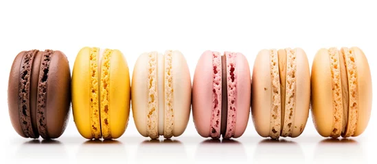 Poster Im Rahmen Five French macarons with various aromas isolated on white in pastel colors orange lemon caramel vanilla and coconut © AkuAku