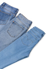 Different stylish jeans isolated on white, above view