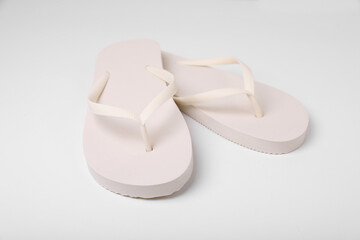 Pair of stylish flip flops on white background