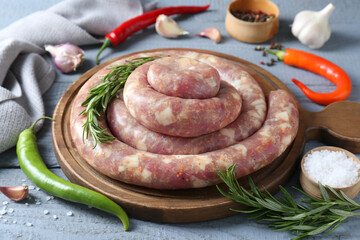Homemade sausages and products on light grey wooden table, closeup
