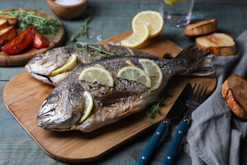 Delicious baked fish served on wooden rustic table. Seafood
