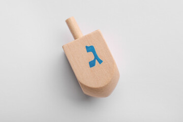 Wooden dreidel on white background, top view. Traditional Hanukkah game