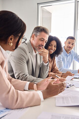 Busy diverse professional business team having discussion at office meeting. Financial advisors or managers consulting senior business man investor talking sitting at conference table. Vertical shot. - obrazy, fototapety, plakaty