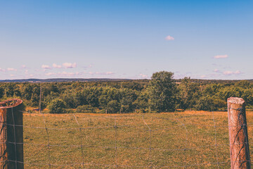 Old school shot of a farm through a fence