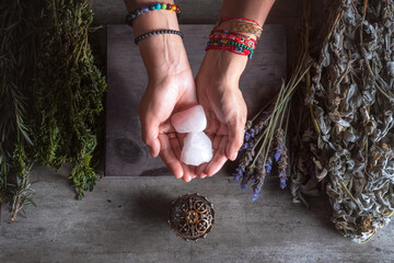 woman holding rose quartz with her hands for spiritual and traditional ritual from the Latin...