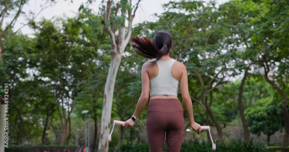 Wall mural woman do jump rope at outdoor