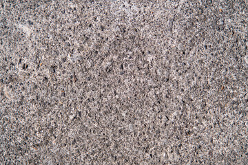 Detailed texture of a dark gray paving block.