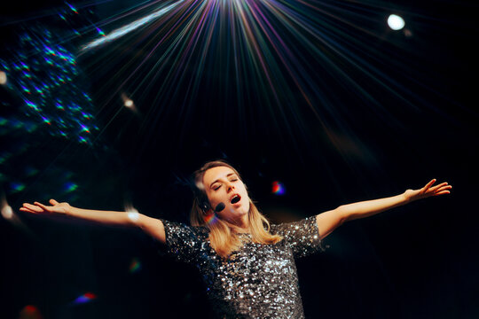 Happy Singer Performing on a Stage at her Own Show. Portrait of a musical artist singing in a concert event
