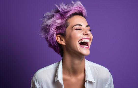 Energetic woman with vibrant purple hair laughing vivaciously against a matching purple backdrop. Ideal for modern beauty campaigns, hair products, and lifestyle promotions.