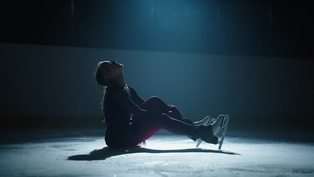 Figure Skater Teen Girl Sitting On Ice And Crying After Falling, Silhouette Of Frustrated Woman