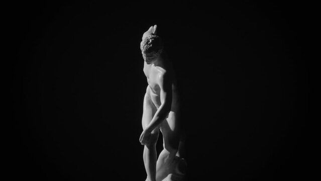 Discobolus (Discus thrower) Greek marble sculpture by Myron, rotating on black background