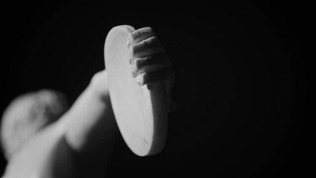 Closeup footage of the hand and discus of the Greek Discobolus marble sculpture by Myron