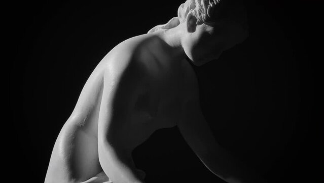 Closeup footage of the upper part of a Greek marble sculpture depicting a Danaide
