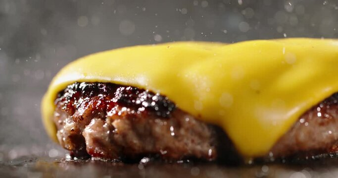 Fried vegetarian cutlets with melted cheese on top. Cinematic advertising plant-based imitation burger cooking. Satisfying meal with crispy texture and rich flavors of fried vegan cutlets. Soy protein