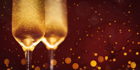 Two New Year's glasses of champagne with highlights on a colored background
