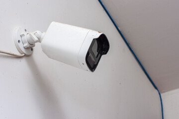 Modern CCTV camera on a wall. CCTV camera install to protect residential area with home security...