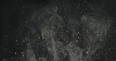 Splashes and smoke from cooking on black background. Cinematic advertising video. Cooking in kitchen. Suitable for videos about any food during frying. Professional quality video