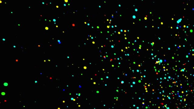 Colorful glitter particles background. Multicolor sparkling particles background. Seamless loop