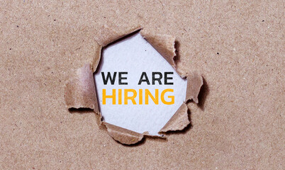 The text YES behind torn brown paper