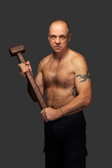 Portrait of a man with naked torso and hammer. With clipping path