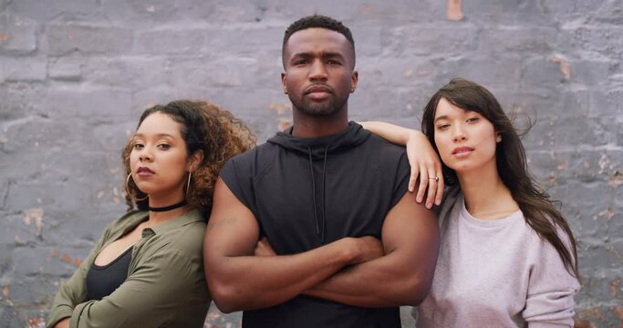 Fashion, diversity and confident friends arms crossed outdoor on a brick wall background together for attitude. Portrait, cool and serious with a group of young people ready for trendy style