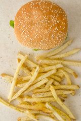 Portobello hamburger with cheese and fries on a table