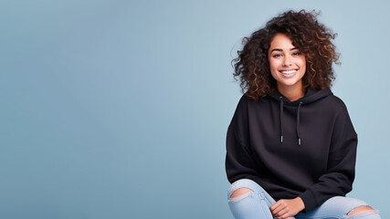 Afro american woman wearing black sweatshirt isolated on pastel
