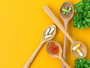 Medical and scientific concepts, spoon with vitamin, medicine, dietary supplements, capsules top view, 3d rendering