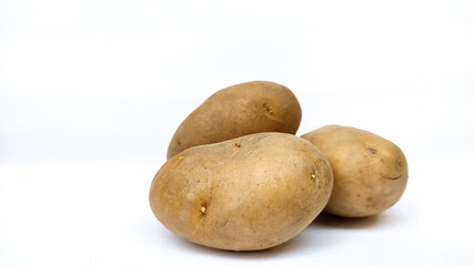 Fototapeta premium three potatoes on white background
